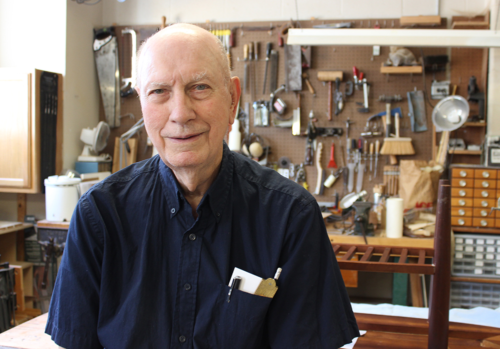Resident poses in woodshop