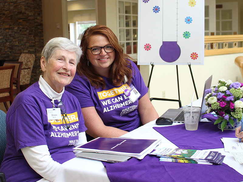 Staff and residents man alzheimer's fundraising desk
