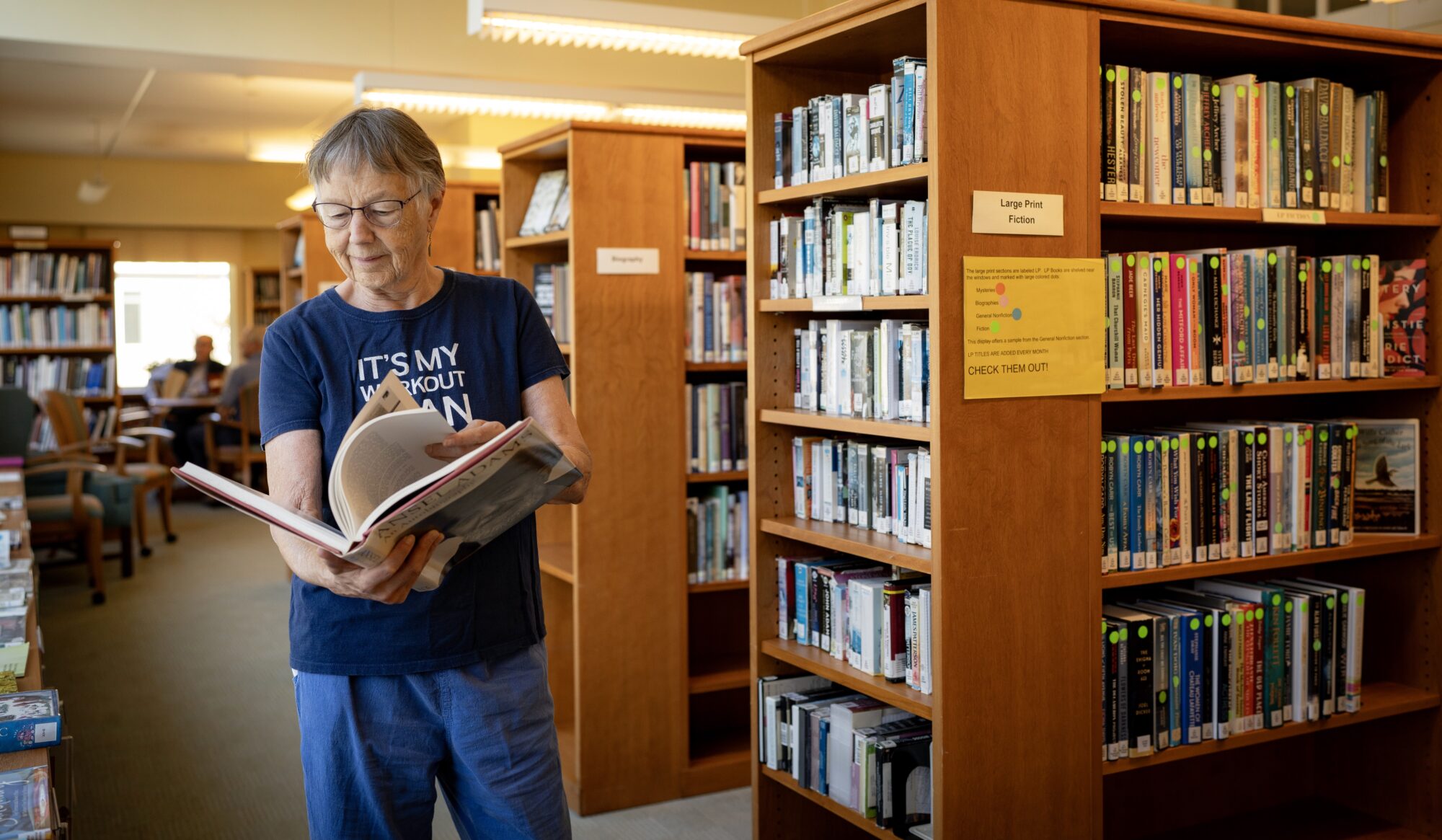 Woman looking at a book in a library.